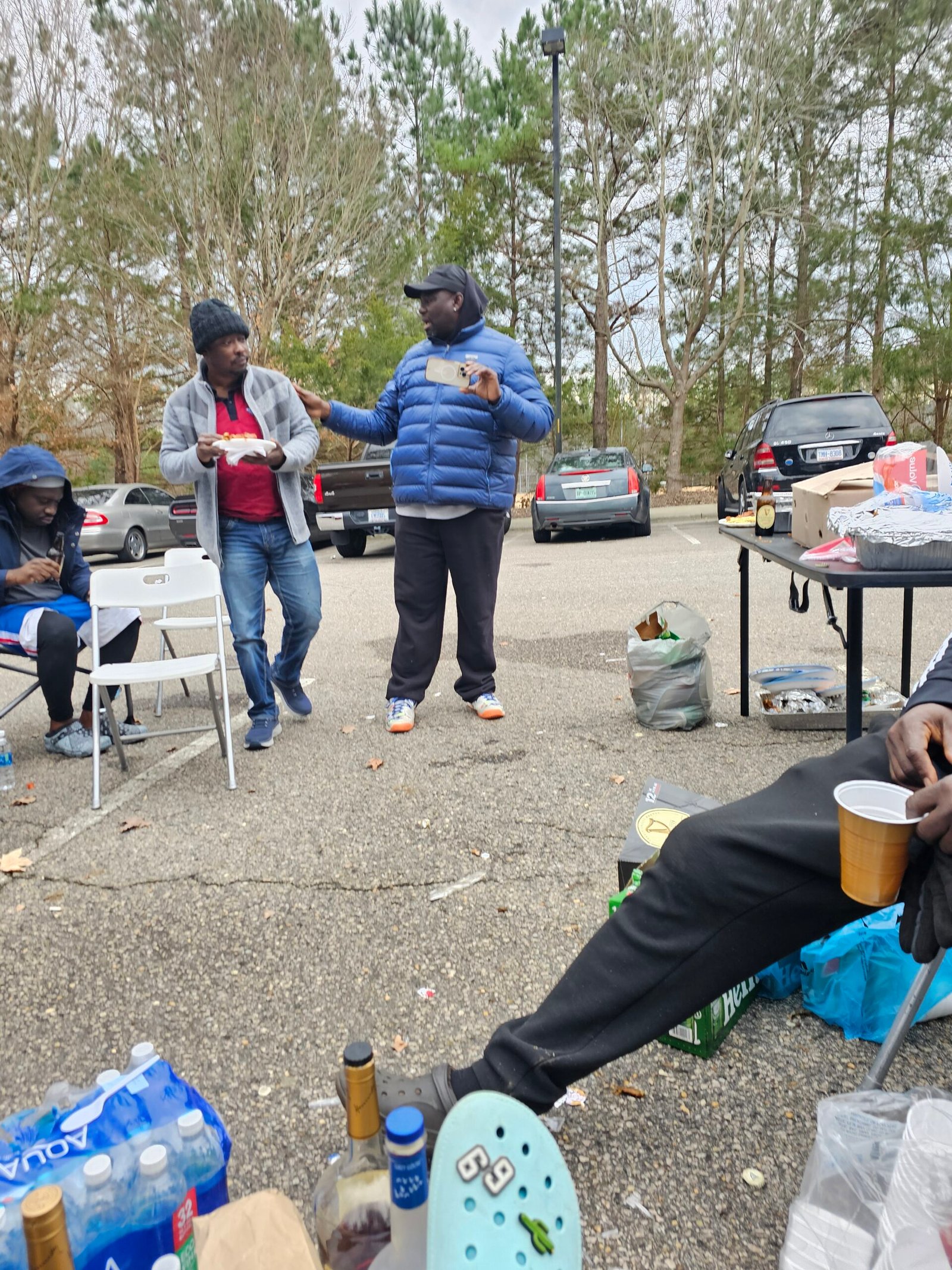 Friends sharing food at an outdoor gathering